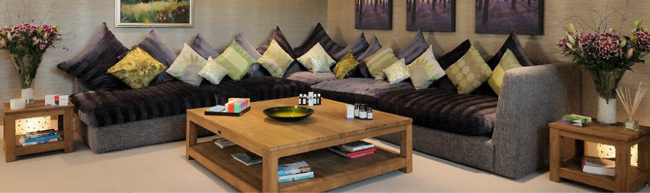 lounge area with coffee table, sofa and cushions